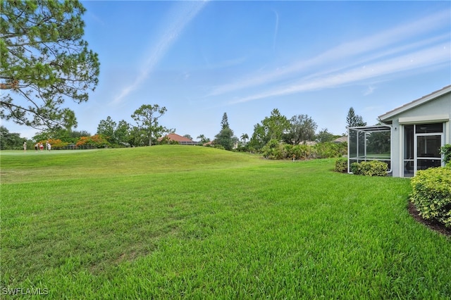2232 Carnaby Ct, Lehigh Acres, FL 33973 - view of green lawn featuring a sunroom