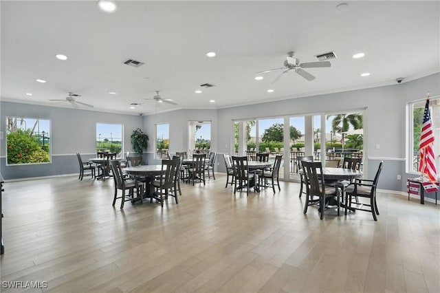 2232 Carnaby Ct, Lehigh Acres, FL 33973 - dining space featuring ceiling fan, recessed lighting, healthy amount of natural light, light wood-type flooring, and ornamental molding