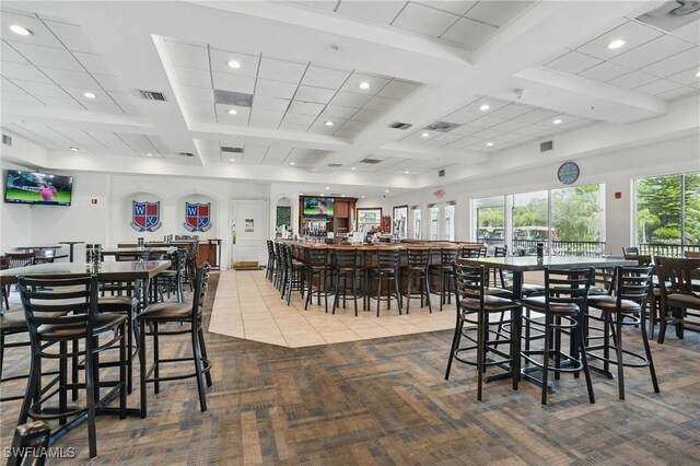 2232 Carnaby Ct, Lehigh Acres, FL 33973 - carpeted dining space featuring coffered ceiling, recessed lighting, beam ceiling, a community bar, and tile patterned floors