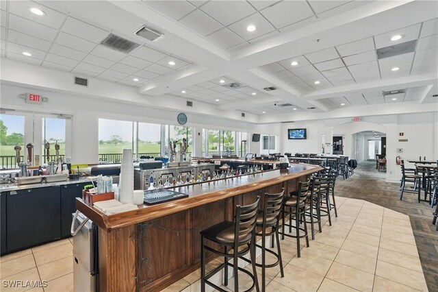 2232 Carnaby Ct, Lehigh Acres, FL 33973 - kitchen featuring open floor plan, dark cabinets, arched walkways, light tile patterned flooring, and recessed lighting