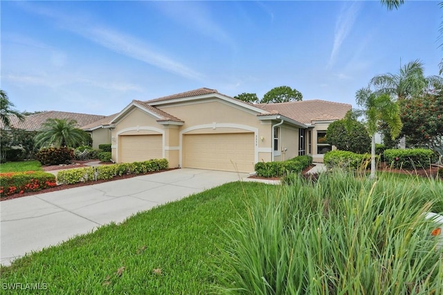 2232 Carnaby Ct, Lehigh Acres, FL 33973 - view of front of property featuring a garage, stucco siding, and driveway