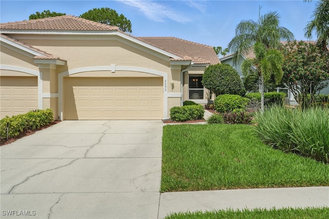2232 Carnaby Ct, Lehigh Acres, FL 33973 - view of front of house with concrete driveway, a garage, stucco siding, and a tile roof