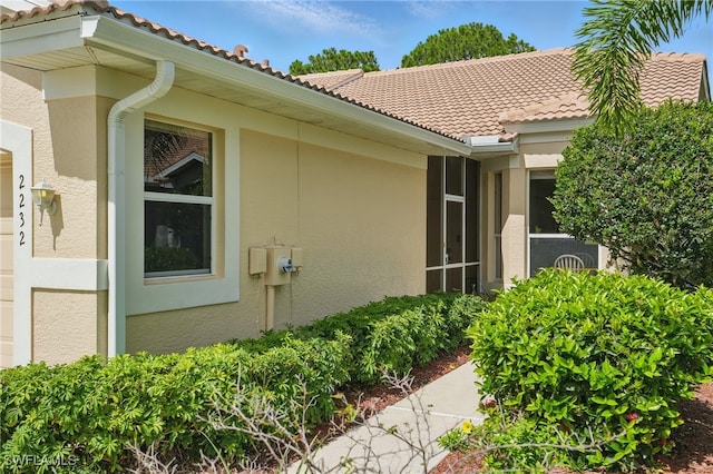 2232 Carnaby Ct, Lehigh Acres, FL 33973 - view of side of property featuring stucco siding and a tile roof