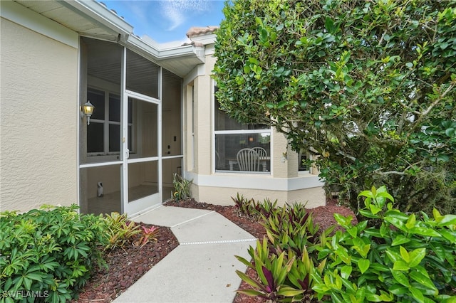 2232 Carnaby Ct, Lehigh Acres, FL 33973 - doorway to property with stucco siding