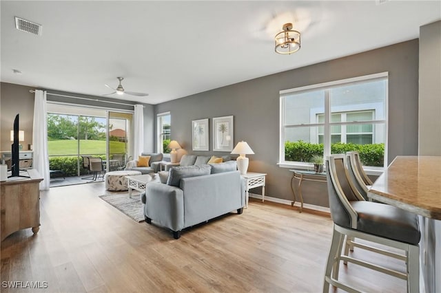 2232 Carnaby Ct, Lehigh Acres, FL 33973 - living area with light wood-style floors and ceiling fan