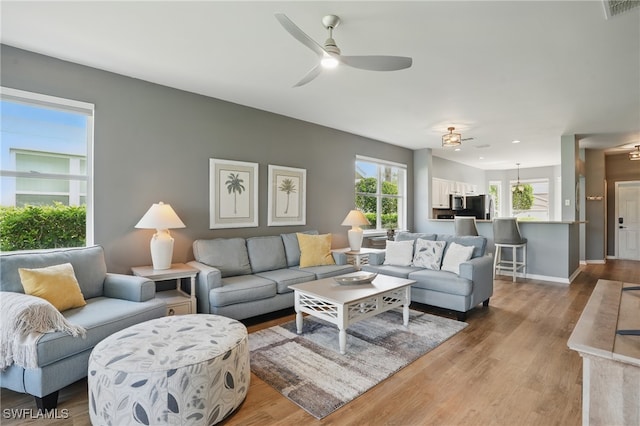 2232 Carnaby Ct, Lehigh Acres, FL 33973 - living area featuring healthy amount of natural light, wood finished floors, ceiling fan, and recessed lighting