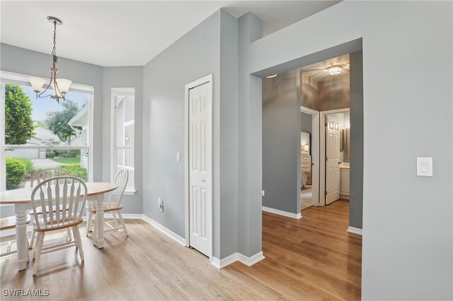 2232 Carnaby Ct, Lehigh Acres, FL 33973 - dining area featuring a chandelier and light wood-style flooring