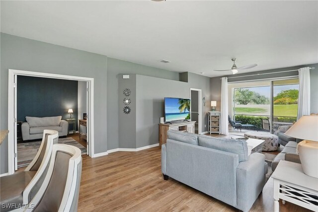 2232 Carnaby Ct, Lehigh Acres, FL 33973 - living area with ceiling fan and light wood-style floors
