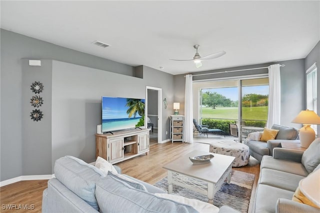 2232 Carnaby Ct, Lehigh Acres, FL 33973 - living area with wood finished floors and a ceiling fan