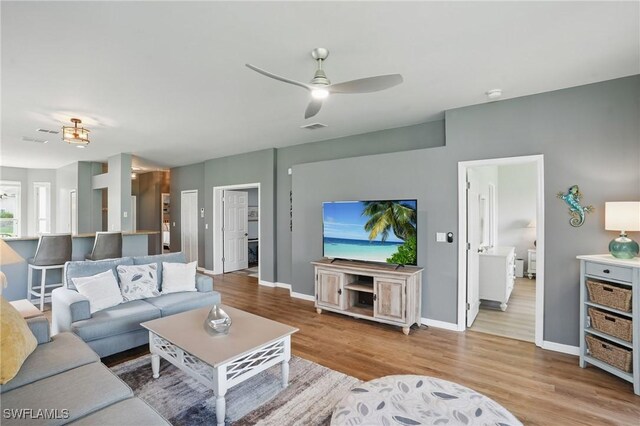 2232 Carnaby Ct, Lehigh Acres, FL 33973 - living room with wood finished floors and a ceiling fan