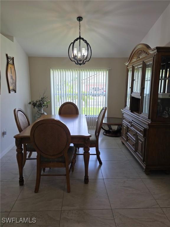 8340 Gassner Way, Lehigh Acres, FL 33972 - dining room featuring a chandelier and baseboards