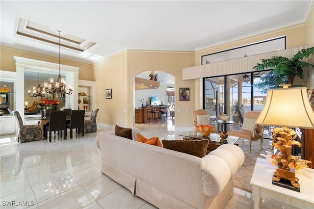 431 Palm Ct, Naples, FL 34108 - living room featuring ornamental molding, arched walkways, tile patterned flooring, and a chandelier