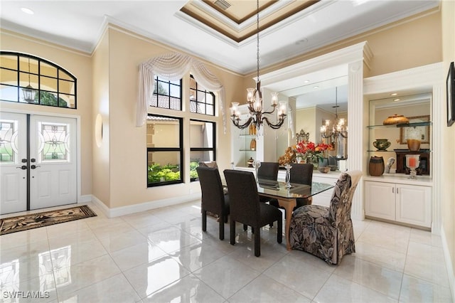 431 Palm Ct, Naples, FL 34108 - dining room with ornamental molding, a chandelier, light tile patterned flooring, and a towering ceiling