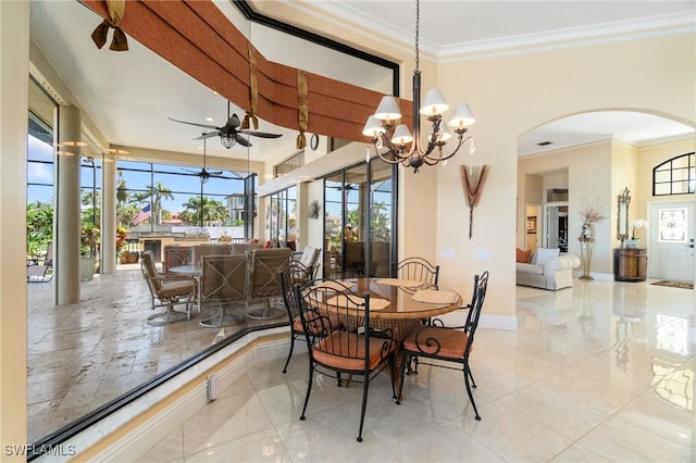 431 Palm Ct, Naples, FL 34108 - dining room with arched walkways, ornamental molding, a ceiling fan, a high ceiling, and a chandelier