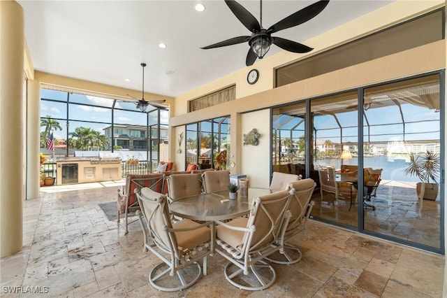 431 Palm Ct, Naples, FL 34108 - sunroom / solarium featuring exterior kitchen, outdoor dining space, and a ceiling fan