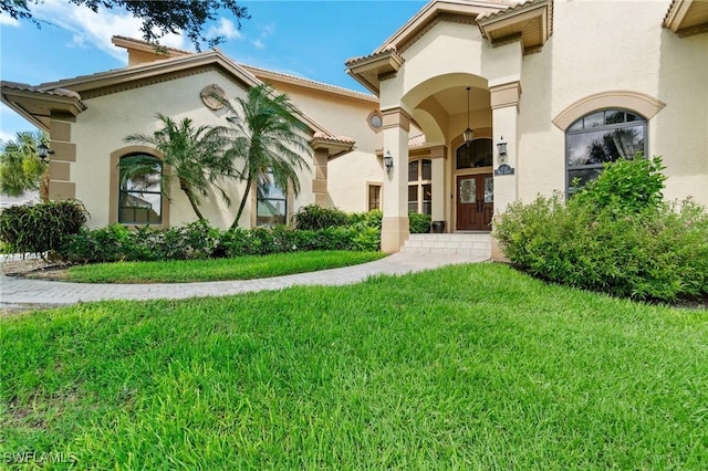 431 Palm Ct, Naples, FL 34108 - mediterranean / spanish house with stucco siding and a front lawn