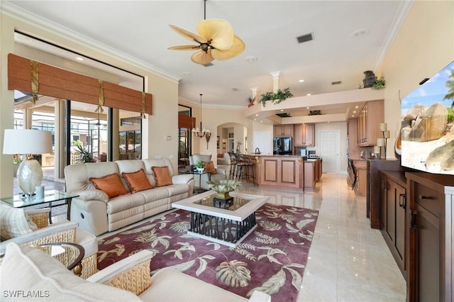 431 Palm Ct, Naples, FL 34108 - living room featuring arched walkways, crown molding, and a ceiling fan