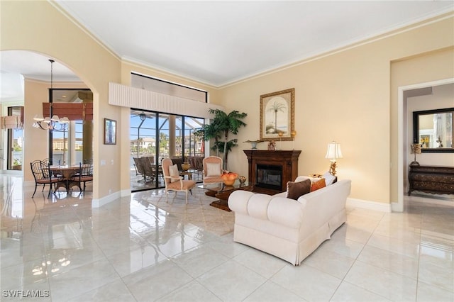 431 Palm Ct, Naples, FL 34108 - living area featuring ornamental molding, a glass covered fireplace, light tile patterned floors, arched walkways, and a chandelier