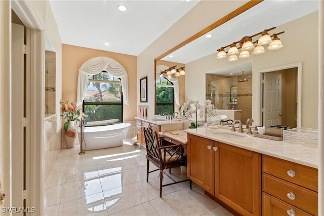 431 Palm Ct, Naples, FL 34108 - bathroom featuring a stall shower, two vanities, a freestanding bath, tile patterned floors, and recessed lighting