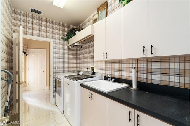 431 Palm Ct, Naples, FL 34108 - laundry area with cabinet space, wallpapered walls, washing machine and dryer, and light tile patterned floors