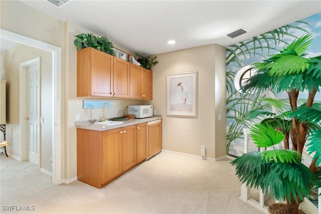431 Palm Ct, Naples, FL 34108 - kitchen featuring white microwave, light carpet, light countertops, and recessed lighting