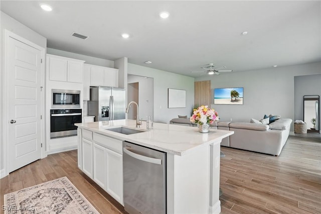 16420 Settlers Way, Punta Gorda, FL 33982 - kitchen featuring stainless steel appliances, open floor plan, an island with sink, a ceiling fan, and recessed lighting