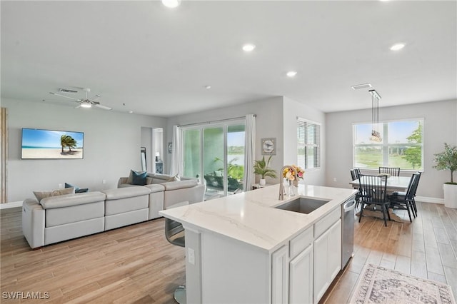 16420 Settlers Way, Punta Gorda, FL 33982 - kitchen featuring light wood finished floors, open floor plan, an island with sink, plenty of natural light, and recessed lighting