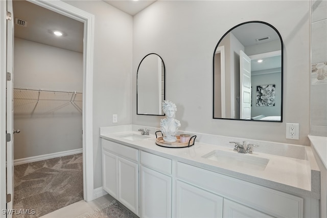 16420 Settlers Way, Punta Gorda, FL 33982 - bathroom featuring double vanity, a spacious closet, and recessed lighting