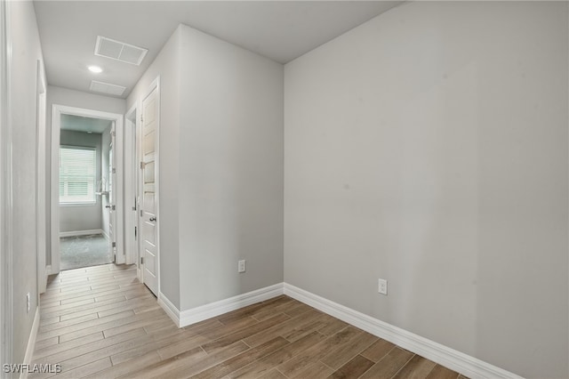 16420 Settlers Way, Punta Gorda, FL 33982 - hallway featuring baseboards and wood finished floors