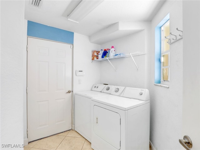 8627 Ibis Cove Cir, Naples, FL 34119 - laundry area featuring washer and dryer and light tile patterned flooring