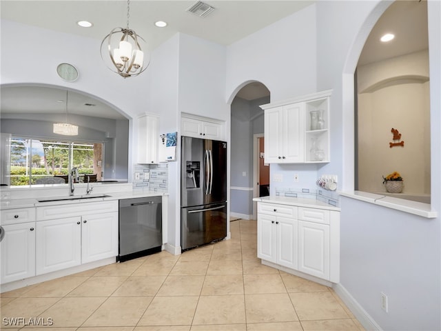 8627 Ibis Cove Cir, Naples, FL 34119 - kitchen with refrigerator with ice dispenser, dishwasher, decorative backsplash, a chandelier, and open shelves
