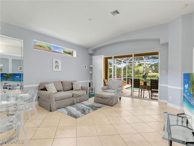 8627 Ibis Cove Cir, Naples, FL 34119 - tiled living room with lofted ceiling and baseboards