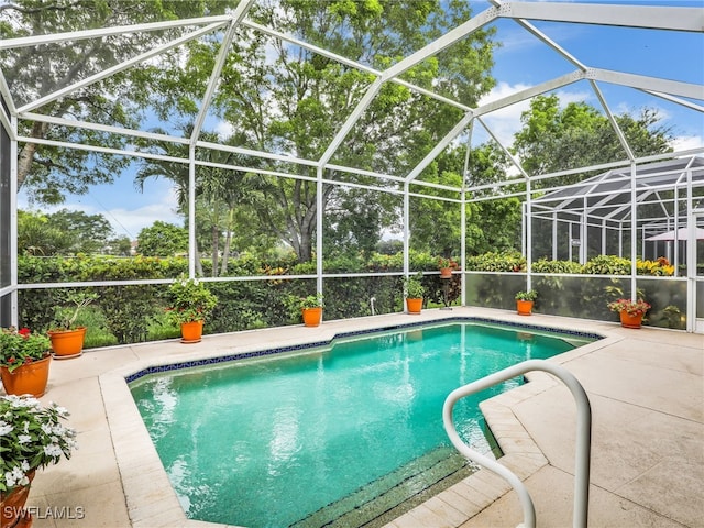 8627 Ibis Cove Cir, Naples, FL 34119 - swimming pool with a patio area and a lanai