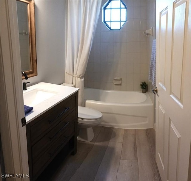 7725 Woodbrook Cir Unit 3504, Naples, FL 34104 - bathroom featuring vanity, shower / tub combo with curtain, and wood finished floors