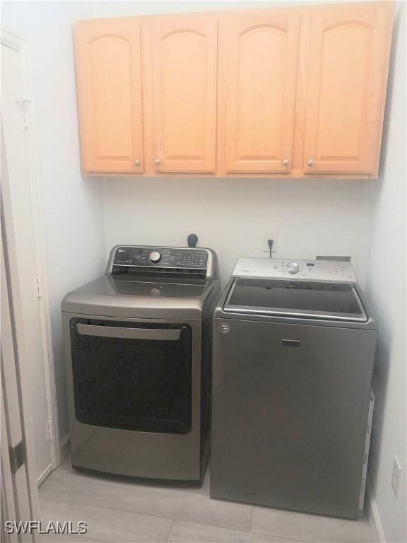 7725 Woodbrook Cir Unit 3504, Naples, FL 34104 - laundry area with washing machine and clothes dryer and cabinet space
