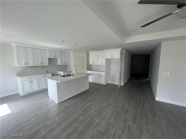 658 Ivanhoe Ave S, Lehigh Acres, FL 33974 - kitchen with baseboards, a sink, dark wood-style floors, white cabinets, and recessed lighting