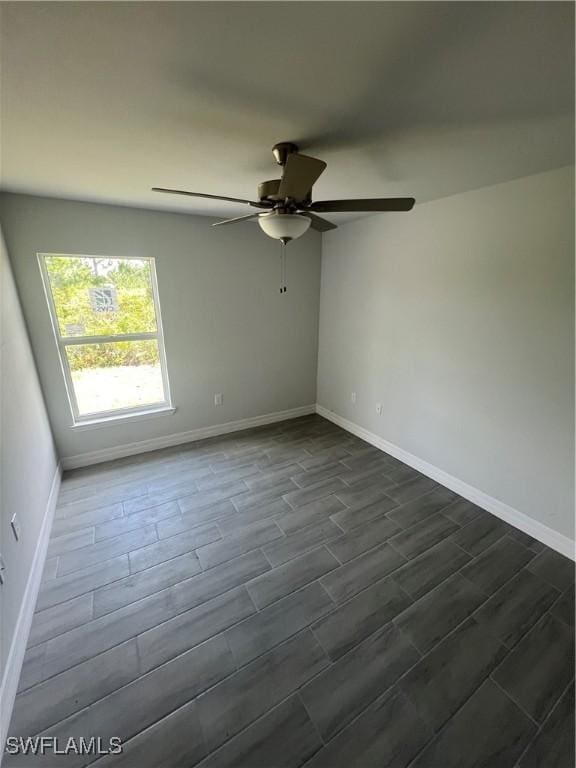 658 Ivanhoe Ave S, Lehigh Acres, FL 33974 - spare room with baseboards, ceiling fan, and wood finish floors