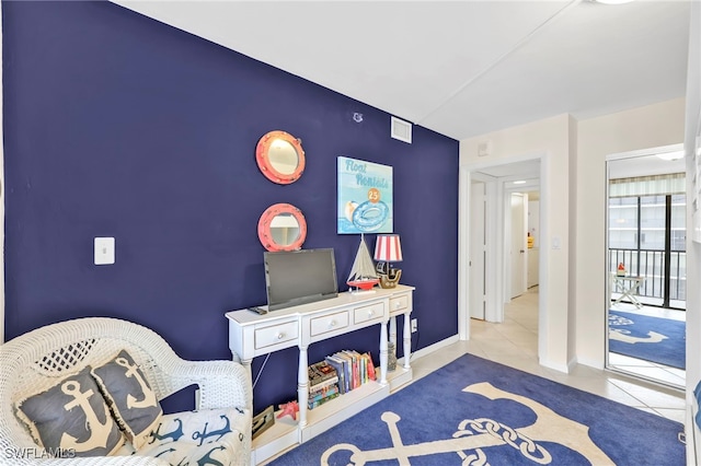 26235 Hickory Blvd Unit 9A, Bonita Springs, FL 34134 - sitting room featuring an accent wall and tile patterned flooring
