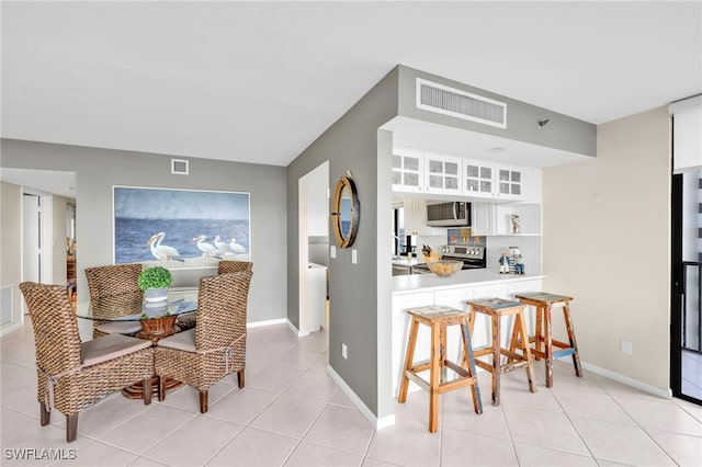 26235 Hickory Blvd Unit 9A, Bonita Springs, FL 34134 - dining room featuring light tile patterned floors and baseboards