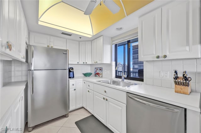 26235 Hickory Blvd Unit 9A, Bonita Springs, FL 34134 - kitchen featuring appliances with stainless steel finishes, white cabinetry, and tasteful backsplash