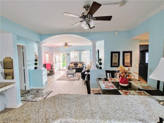 1776 Concordia Lake Cir Unit 2902, Cape Coral, FL 33909 - dining space featuring decorative columns, a ceiling fan, wood finished floors, arched walkways, and crown molding