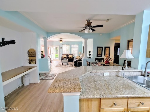 1776 Concordia Lake Cir Unit 2902, Cape Coral, FL 33909 - kitchen featuring ornate columns, ceiling fan, open floor plan, a sink, and ornamental molding