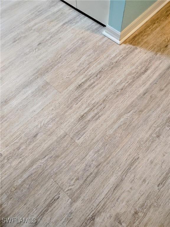1776 Concordia Lake Cir Unit 2902, Cape Coral, FL 33909 - detailed view of wood finished floors and baseboards