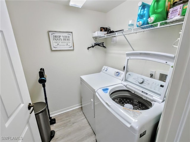 1776 Concordia Lake Cir Unit 2902, Cape Coral, FL 33909 - laundry area with independent washer and dryer, light wood finished floors, and baseboards