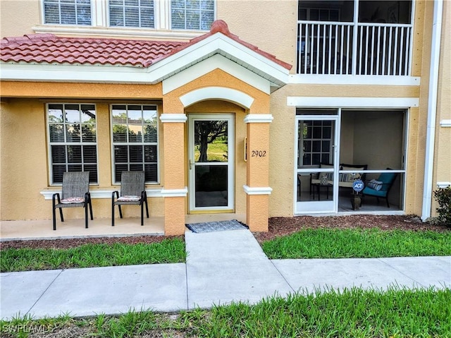 1776 Concordia Lake Cir Unit 2902, Cape Coral, FL 33909 - doorway to property featuring stucco siding and a tiled roof