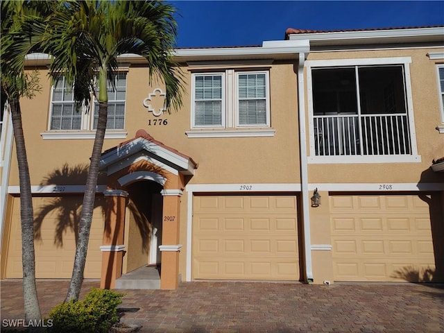 1776 Concordia Lake Cir Unit 2902, Cape Coral, FL 33909 - townhome / multi-family property featuring stucco siding, a garage, and driveway