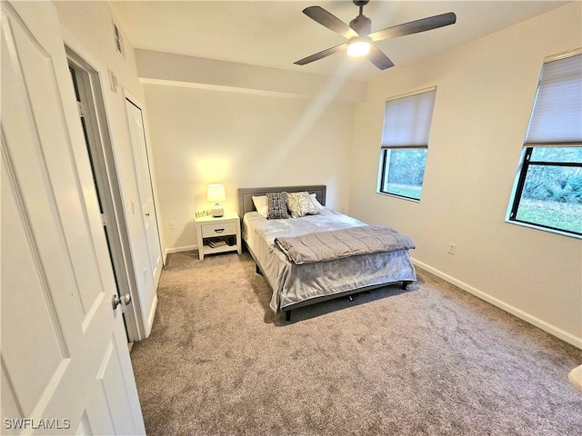 12975 Positano Cir Unit 104, Naples, FL 34105 - bedroom featuring carpet, multiple windows, and ceiling fan
