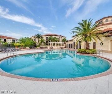12975 Positano Cir Unit 104, Naples, FL 34105 - community pool with a patio