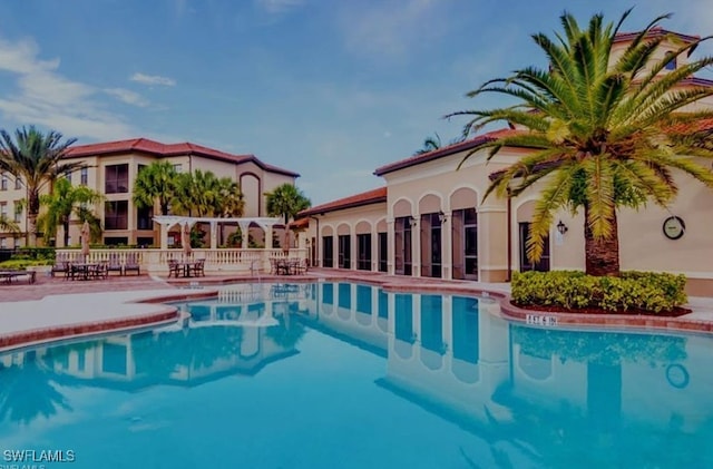 12975 Positano Cir Unit 104, Naples, FL 34105 - community pool featuring a patio