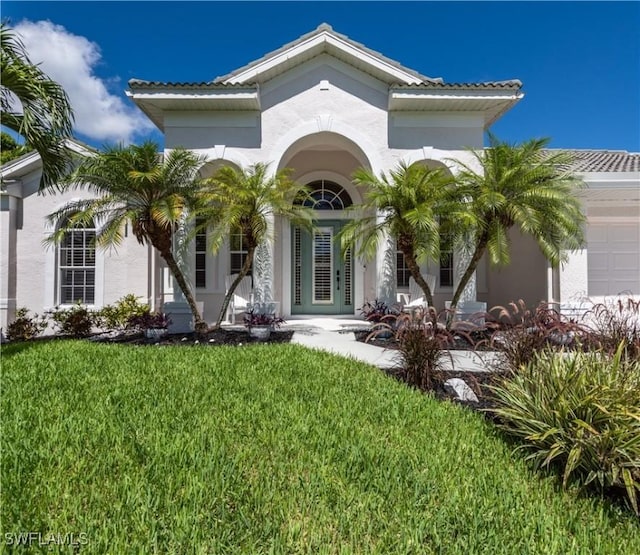 17091 Laurelin Ct, North Fort Myers, FL 33917 - view of front facade with a front lawn, stucco siding, and an attached garage